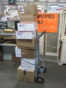 Stack of boxes ready for shipping on a dolly.