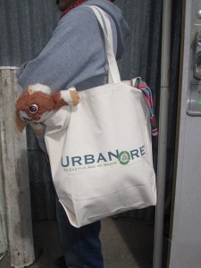 Picture of a person carrying a canvas bag full of clothes and stuffed animals